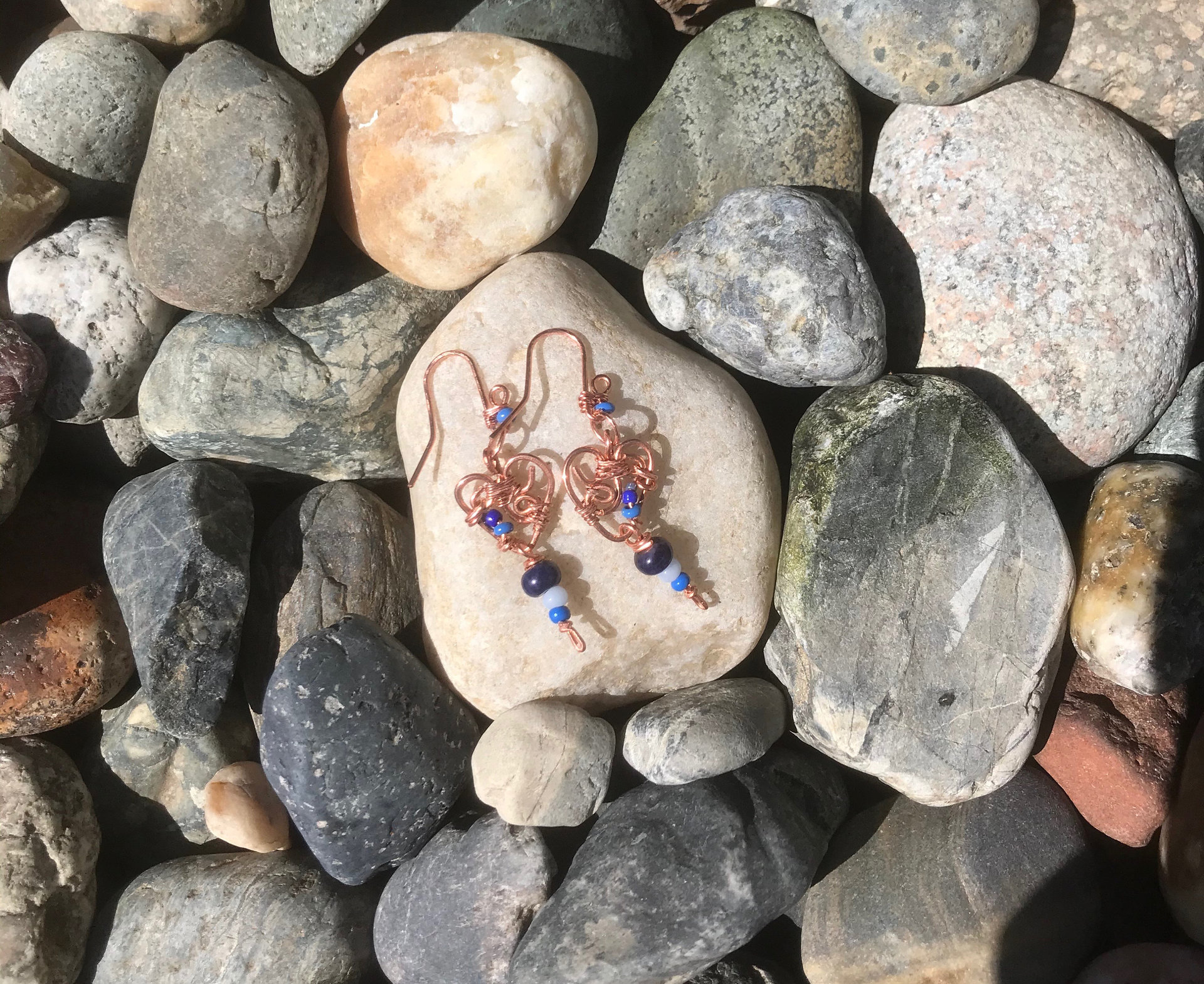 Deep Blue Lapis lazuli and Sky Blue Cat's Eye Glass playfully Dangle from the Handcrafted Beaded Copper Heart French Wire Earrings