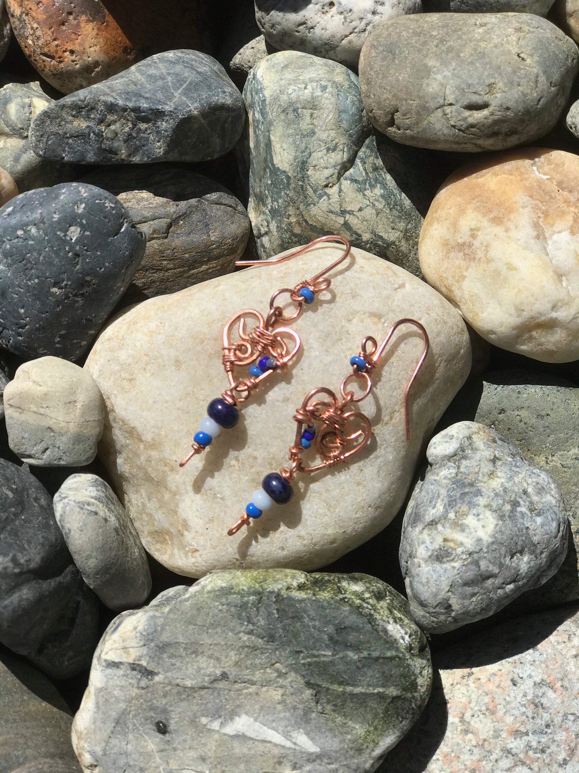 Deep Blue Lapis lazuli and Sky Blue Cat's Eye Glass playfully Dangle from the Handcrafted Beaded Copper Heart French Wire Earrings