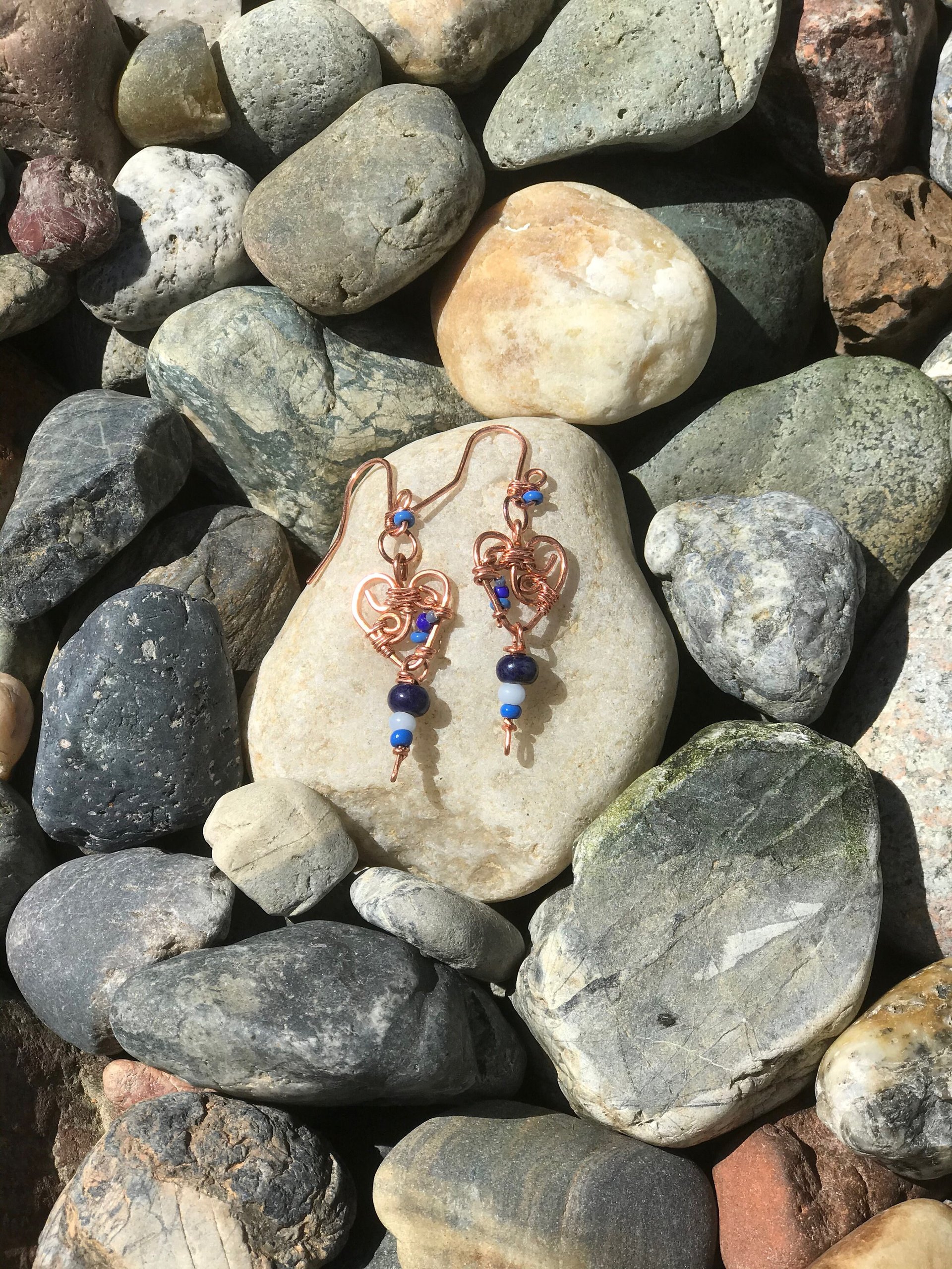 Deep Blue Lapis lazuli and Sky Blue Cat's Eye Glass playfully Dangle from the Handcrafted Beaded Copper Heart French Wire Earrings