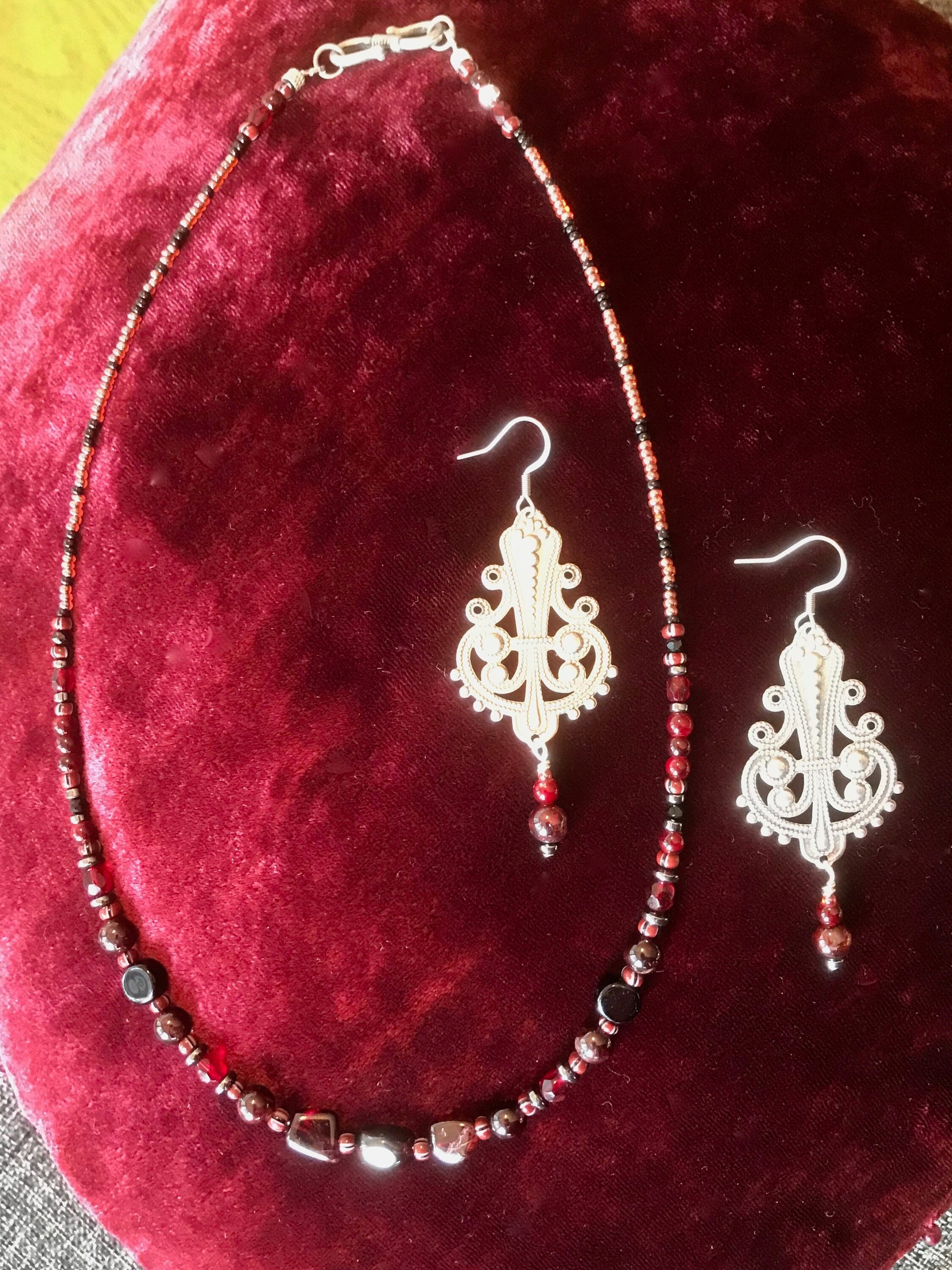 Dark and Alluring Garnet, Hematite, Faceted Glass and Bead Necklace with Pressed Metal Chandelier and Garnet Dangle Earring Set