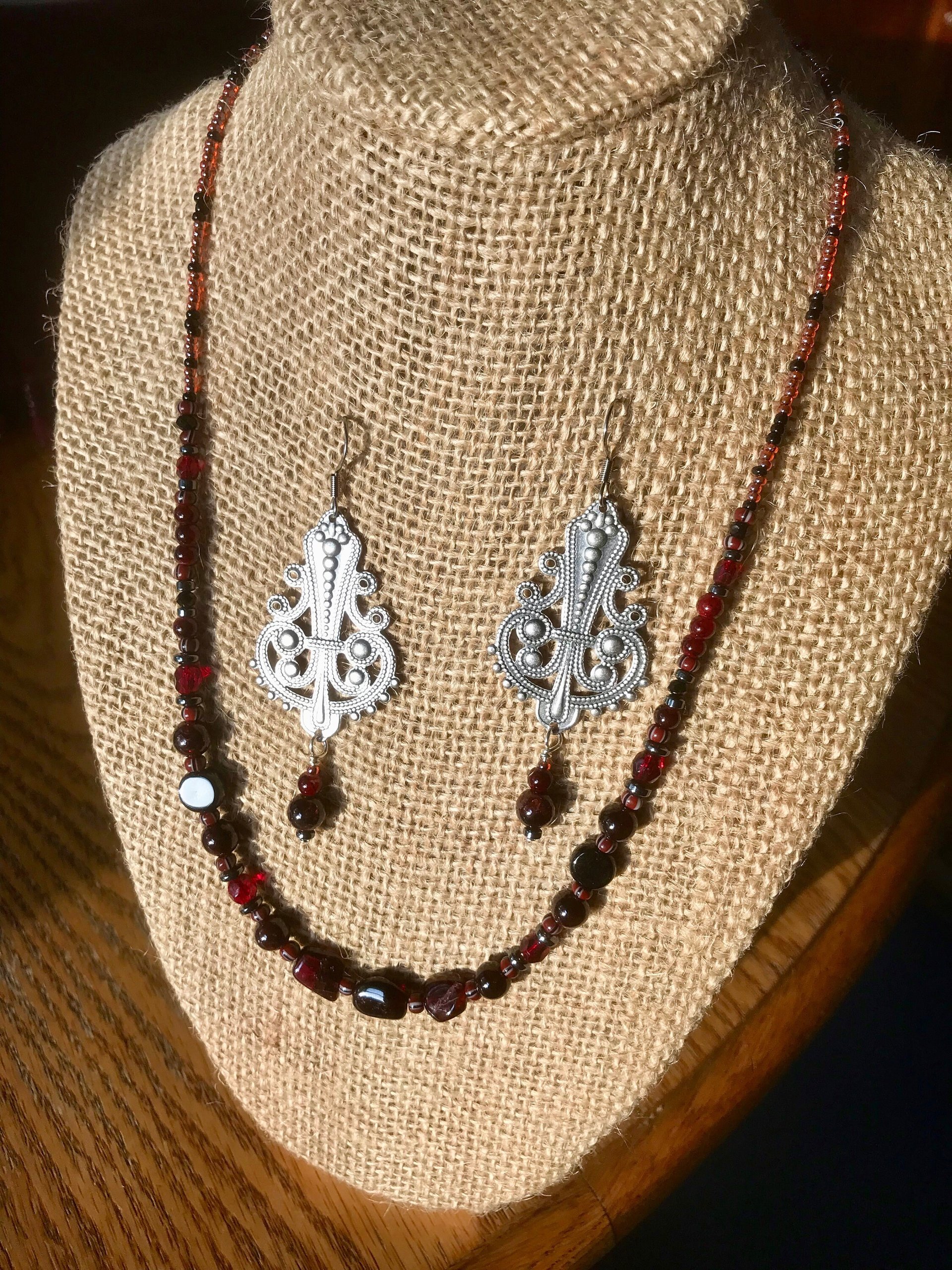 Dark and Alluring Garnet, Hematite, Faceted Glass and Bead Necklace with Pressed Metal Chandelier and Garnet Dangle Earring Set