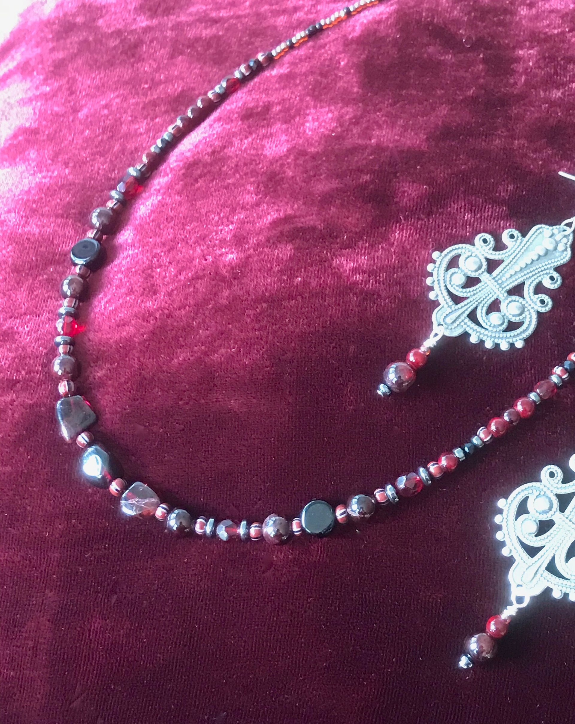 Dark and Alluring Garnet, Hematite, Faceted Glass and Bead Necklace with Pressed Metal Chandelier and Garnet Dangle Earring Set