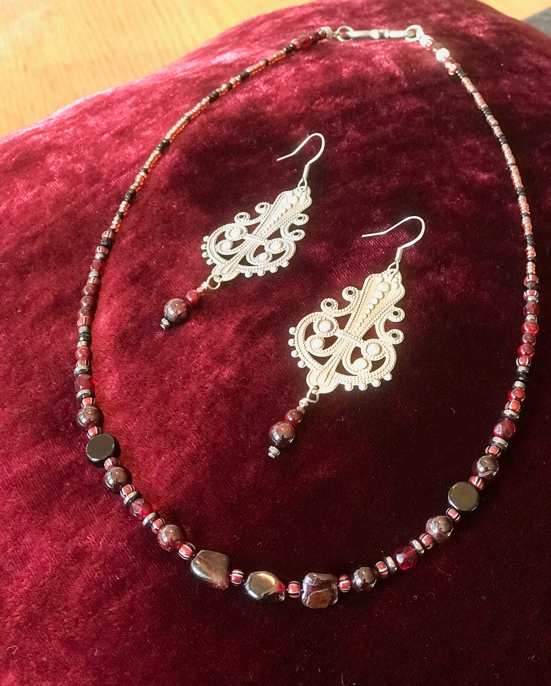Dark and Alluring Garnet, Hematite, Faceted Glass and Bead Necklace with Pressed Metal Chandelier and Garnet Dangle Earring Set